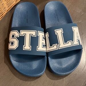 Stella McCartney blue slides with White Lettering